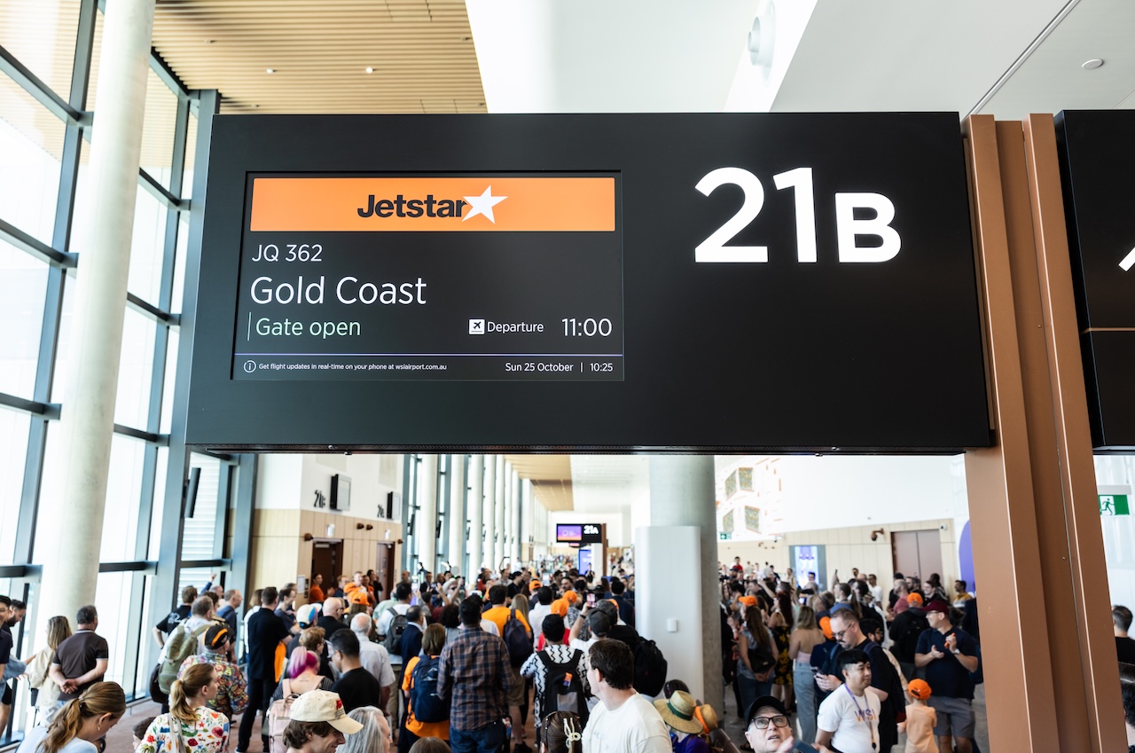 A board announcing flight JQ362 at WSI